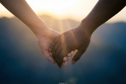 Two people holding hands symbolizing how to build trust in a relationship through connection and emotional vulnerability